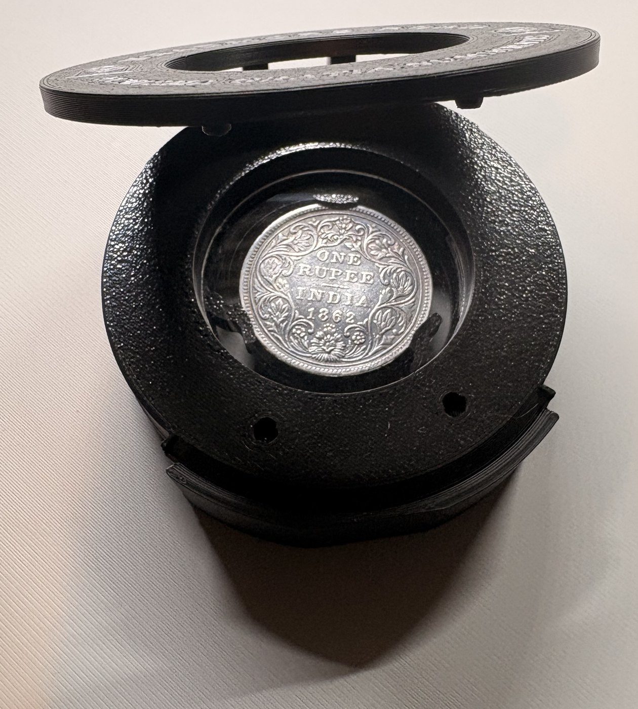 Lid open, coin laid on the window